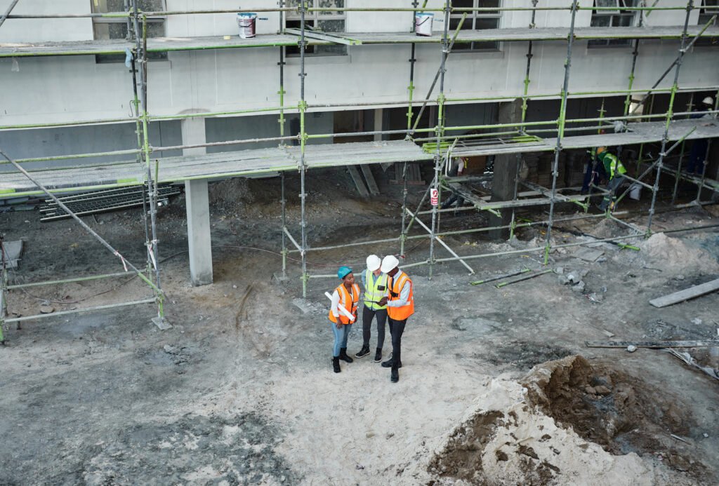 Construction site team reviewing health and safety standards